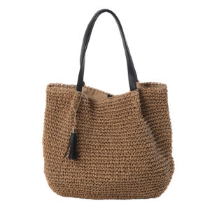 Front view of the French retro style large woven shoulder bag featuring tassel decorations.