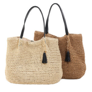 Close-up detail shot highlighting the texture of the handmade straw weave and the attached tassel.