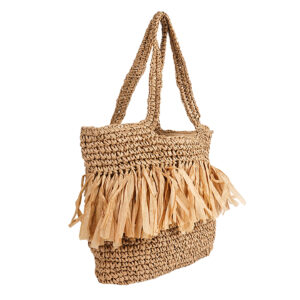 Close-up of the decorative tassel accents on the straw tote bag.