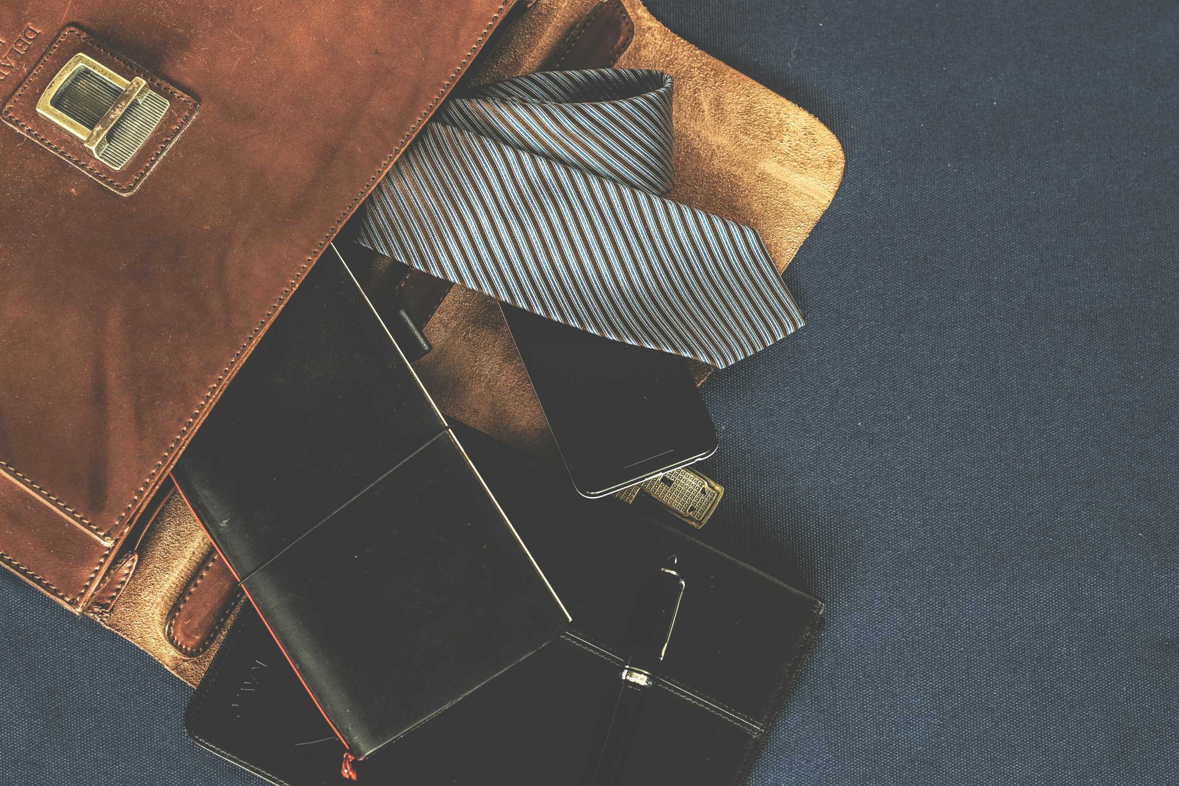 black-leather-wallet-near-the-necktie Photo by Lum3n