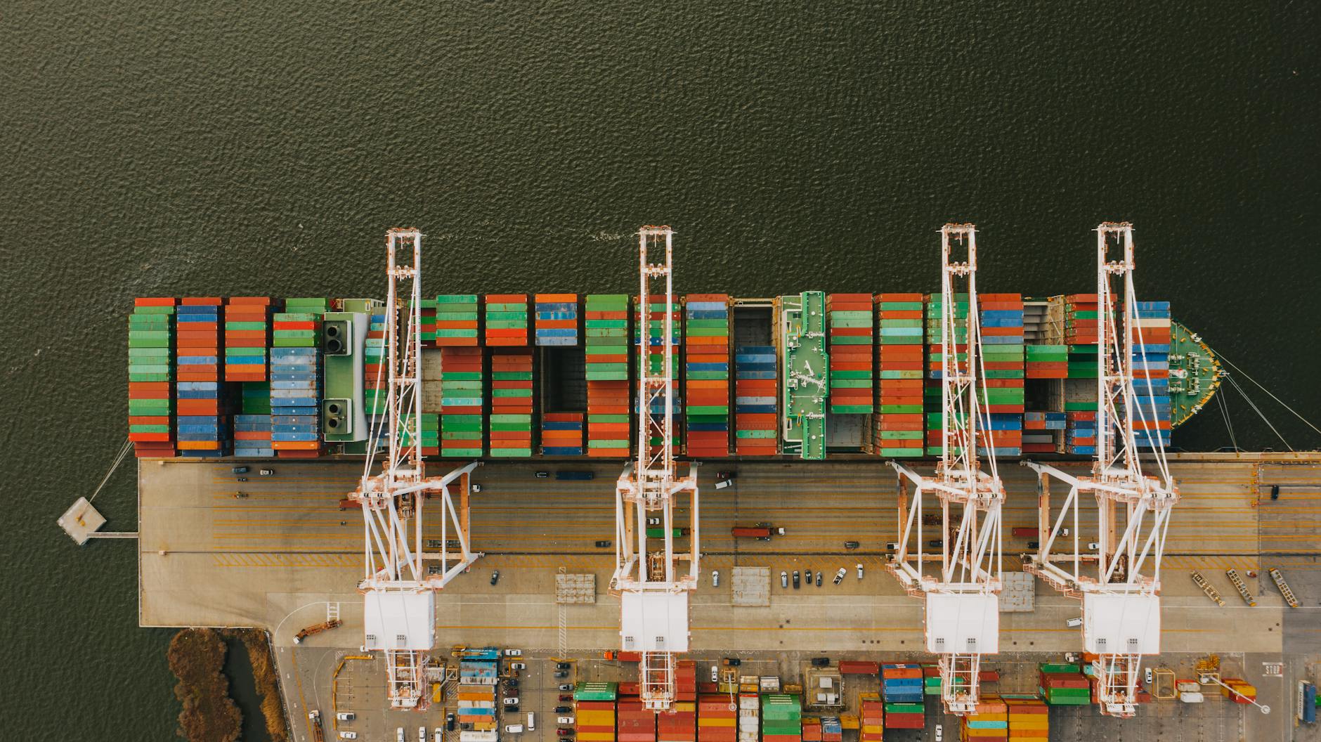 Workers loading containers on a ship illustrating Free on Board (FOB) transfer point for custom apparel shipments-photo-by-pexels