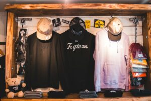 tylish-clothes-on-counter-in-shop Photo by Erik Mclean